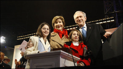 President George W. Bush and Mrs. Laura Bush are joined by tree lighters Kayleigh Kepler, 11, left, and Lindsey Van Horn, 9, during the 2008 Lighting of the National Christmas Tree Thursday, Dec. 4, 2008, on the Ellipse in Washington, D.C.