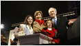 President George W. Bush and Mrs. Laura Bush are joined by tree lighters Kayleigh Kepler, 11, left, and Lindsey Van Horn, 9, during the 2008 Lighting of the National Christmas Tree Thursday, Dec. 4, 2008, on the Ellipse in Washington, D.C.