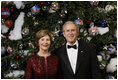 President George W. Bush and Mrs. Laura Bush pose for their 2008 holiday portrait Sunday, Dec. 7, 2008, in the Blue Room of the White House.