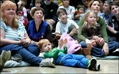 Children, their families and staff at Children's National Medical Center in Washington, D.C. watch the debut of Barney Cam VII: A Red, White & Blue Christmas, which Mrs. Laura Bush debuted Monday, Dec. 15, 2008 during her annual visit to the hospital. The crowd got to see the video about the Bush pets - dogs Barney and Miss Beazley and Willard the cat - which can be seen on the White House web site. Mrs. Bush read the book "My Penguin Osbert" to the group and visited patients.