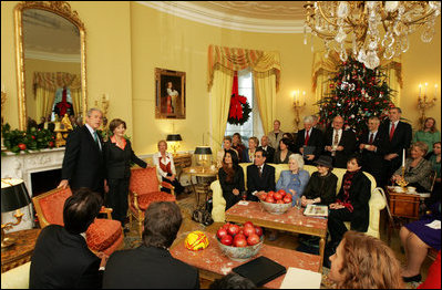 President George W. Bush and Mrs. Laura Bush stand in the Yellow Oval Room in the Private Residence of the White House Thursday, Dec. 18, 2008, after the President dropped in on a coffee in honor of the U.S. Afghan Women's Council.