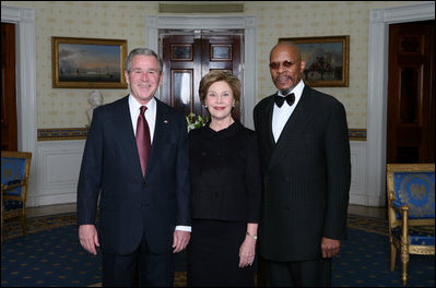 President George W. Bush and First Lady Laura Bush pose for photos with actor Avery Brooks prior to a ceremony in the East Room of the White House honoring Abraham Lincoln's 199th Birthday, Sunday, Feb. 10, 2008.