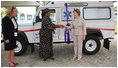 Mrs. Laura Bush and Mrs. Salma Kikwete, First Lady of Tanzania, exchange handshakes after Mrs. Bush presented Mrs. Kikwete with keys to an ambulance Sunday, Feb. 17, 2008, during her visit to Dar es Salaam. The ambulance will be donated to Sokoine Regional Hospital and will be used in the Lindi Region, one of the poorest and neediest in the country. The donation was a result of a joint visit to the hospital by Mrs. Kikwete and Pam White, left, USAID Mission Director.