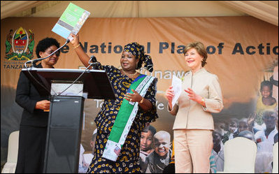 Mrs. Laura Bush applauds as Mrs. Salma Kikwete, First Lady of Tanzania, holds up the National Costed Plan of Action for Most Vulnerable Children, 2007-2010, supported both financially and technically by PEPFAR and UNICEF, during the visit by Mrs. Bush to the WAMA Foundation in Dar es Salaam.