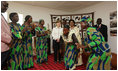 Mrs. Laura Bush and Madame Chantal de Souza Yayi, wife of President Boni Yayi of Benin, watch as representatives of the USAID-Supported Mothers' Association perform Saturday, Feb. 16, 2008, during their visit in Cotonou, Benin.