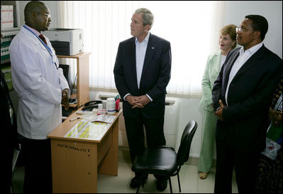 President George W. Bush and Mrs. Laura Bush, joined by Tanzanian President Jakaya Kikwete, visit with a staff doctor Sunday, Feb. 17, 2008, at the Amana District Hospital in Dar es Salaam, Tanzania, where President Bush and Mrs. Bush visited a patients and staff at the hospital's care and treament clinic.
