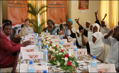 Mrs. Laura Bush and Mrs. Salma Kikwete sit at the head of the table during a roundtable Sunday, Feb. 17, 2008, in Dar es Salaam, with Madrasa graduates who have received HIV prevention education as part of their religious instruction. Madrasa training is comparable to the training students in the U.S. receive in Sunday school or Hebrew school.