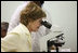 Mrs. Laura Bush views a medical slide thru a microscope Monday, Feb. 18, 2008, during a tour of the Meru District Hospital outpatient clinic in Arusha, Tanzania.