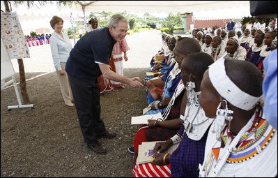 President George W. Bush, joined by Mrs. Laura Bush, greets guests, students and their families during a welcome program Monday, Feb. 18, 2008, to the Maasai Girls School in Arusha, Tanzania.