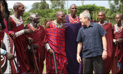 President George W. Bush joins members of a Maasai warrior dance group during their performance to welcome President Bush and Mrs. Laura Bush Monday, Feb. 18, 2008, to the Maasai Girls School in Arusha, Tanzania.