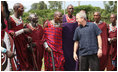 President George W. Bush joins members of a Maasai warrior dance group during their performance to welcome President Bush and Mrs. Laura Bush Monday, Feb. 18, 2008, to the Maasai Girls School in Arusha, Tanzania.