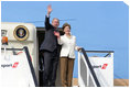 President George W. Bush and Mrs. Laura Bush wave from the steps of Air Force One Feb. 19, 2008, as they depart from Julius Nyerere International Airport in Dar es Salaam, Tanzania. The President and Mrs. Bush are on their way to Rwanda, the third stop of their five-nation tour.