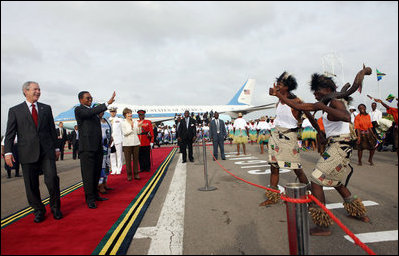 President George W. Bush and President Jakaya Kikwete of Tanzania are joined by Salma Kikwete, spouse of President Jakaya Kikwete, and Mrs Laura Bush as they watch a cultural performance Tuesday, Feb. 19, 2008, at the Julius Nyerere International Airport in Dar es Salaam, Tanzania before their departure to Kigali, Rwanda.