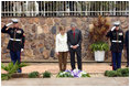 Flanked by saluting U.S. Marines President George W. Bush and Mrs. Laura Bush pause for a moment of silence after laying a wreath on a mass grave at the genocide memorial Tuesday, Feb. 19, 2008, at the Kigali Memorial Centre in Kigali, Rwanda.