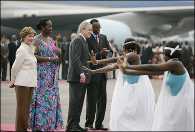 President George W. Bush and Mrs. Laura Bush are welcomed Tuesday, Feb. 19, 2008 by Rwanda President Paul Kagame and his wife, Jeannette Kagame, on their arrival to Kigali International Airport in Kigali, Rwanda.