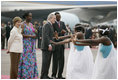President George W. Bush and Mrs. Laura Bush are welcomed Tuesday, Feb. 19, 2008 by Rwanda President Paul Kagame and his wife, Jeannette Kagame, on their arrival to Kigali International Airport in Kigali, Rwanda.