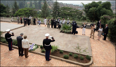 President George W. Bush and Mrs. Laura Bush pause for a moment of silence after laying a wreath on a mass grave at the genocide memorial Tuesday, Feb. 19, 2008, at the Kigali Memorial Centre in Kigali, Rwanda.