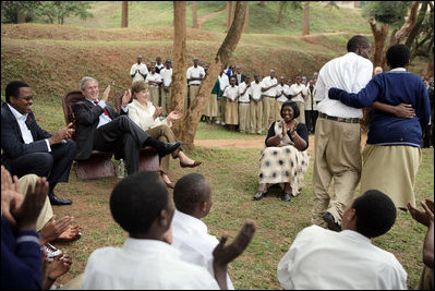President George W. Bush and Mrs. Laura Bush applaud after a theatrical performance by members of the Lycee de Kigali 'Anti-AIDS Club' Tuesday Feb. 19, 2008, outside of the Lycee de Kigali in Kigali, Rwanda.