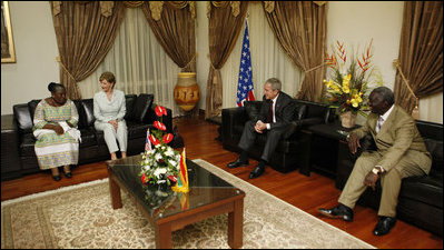 President George W. Bush and Mrs. Laura Bush visit with Ghana President John Agyekum Kufuor and first lady Theresa Kufuor, upon their arrival Tuesday, Feb. 19, 2008, to Kotoka International Airport in Accra, Ghana.