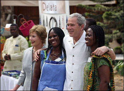 President George W. Bush and Mrs. Laura Bush pose for a photo with two women Wednesday, Feb. 20, 2008, during his visit to the International Trade Fair Center in Accra, Ghana.