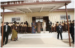 Mrs. Laura Bush and Ghana first lady Mrs. Theresa Kufuor are greeted by students and school officials on their arrival to Mallam D/A Primary School, Wednesday, Feb. 20, 2008 in Accra, Ghana.