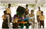Mrs. Laura Bush participates in a reading lesson with students in their "reading hut" with the school’s reading mascot Wednesday, Feb. 20, 2008, at the Mallam D/A/ Primary School in Accra, Ghana.