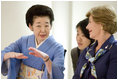 As Mrs. Laura Bush listens, Mrs. Kiyoko Fukuda, spouse of Prime Minister Yasuo Fukuda of Japan, explains the finer details on proper dressing techniques during a demonstration for G-8 spouses of a Junihitoe 12-layered Ancient Kimono Monday, July 7, 2008, at the Windsor Hotel Toya Resort and Spa in Toyako, Japan.