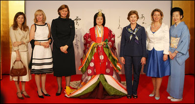 Spouses of G-8 leaders pose with a model dressed in a Junihitoe, a 12-layered ancient kimono, following a demonstration of traditional Japanese culture Monday, July 7, 2008, in Toyako, Japan. From left, the spouses are: Mrs. Margarida Uva Barroso, Mrs. Laureen Harper, Mrs. Sarah Brown, Mrs. Laura Bush, Mrs. Svetlana Medvedeva, and Mrs. Kiyoko Fukuda.