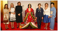 Spouses of G-8 leaders pose with a model dressed in a Junihitoe, a 12-layered ancient kimono, following a demonstration of traditional Japanese culture Monday, July 7, 2008, in Toyako, Japan. From left, the spouses are: Mrs. Margarida Uva Barroso, Mrs. Laureen Harper, Mrs. Sarah Brown, Mrs. Laura Bush, Mrs. Svetlana Medvedeva, and Mrs. Kiyoko Fukuda.