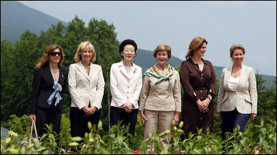 With Mt. Yoteizan as a backdrop, the G-8 Spouses pause Tuesday, July 8, 2008, for their family photo in the village of Makkari on the northern Japanese island of Hokkaido.
