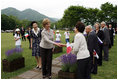Mrs. Laura Bush, accompanied by Mrs. Kiyoko Fukuda, spouse of the Prime Minister of Japan, left, is greeted as she arrives to the Toyako New Mount Showa Memorial Park for a ceremonial tree planting ceremony with other G-8 spouses Wednesday, July 9, 2008, in Hokkaido, Japan. 