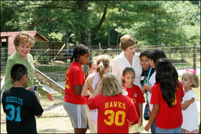 Mrs. Laura Bush, joined by North Carolina Senator Elizabeth Dole, left, greets Junior Ranger participates at a poetry reading event Monday, July 28, 2008, during a tour of the Carl Sandburg Home National Historic Site in Flat Rock, N.C.