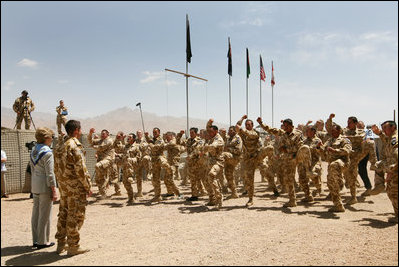 Mrs. Laura Bush is greeted Sunday, June 8, 2008, by New Zealand troops performing a traditional warrior dance at the Bamiyan Provincial Reconstruction Team Base in Afghanistan's Bamiyan province. Standing with her is Major Justin de la Haye.