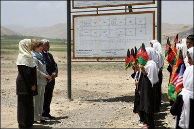 Mrs. Laura Bush is greeted by future students of the Ayenda Learning Center during her visit to the school's construction site Sunday, June 8, 2008, in Bamiyan, Afghanistan. Joining Mrs. Bush is Governor of Bamiyan Province Habiba Sarabi, left, and Ihsan Ullah Bayat, who directed a tour of the site. 