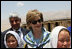 Mrs. Laura Bush is joined by Ihsan Ullah Bayat, top let, and young Afghan girls during a tour of the construction site of the Ayenda Learning Center Sunday, June 8, 2008, in Bamiyan, Afghanistan.