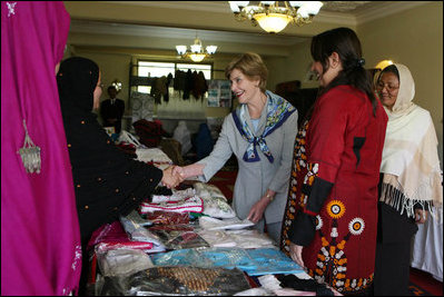 Mrs. Laura Bush greets local businesswomen as she tours the marketplace of the Arzu and Bamiyan Women's Business Association on June 9, 2008 in Afghanistan. The carpets, embroidery and other Afghan wares are all made by women.