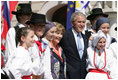 President George W. Bush and Laura Bush pose for a photo with children dressed in traditional outfits during their visit Tuesday, June 10, 2008, to the Lipizzaner Horse Exhibition at Brdo Castle in Kranj, Slovenia.