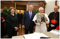 President George W. Bush and Laura Bush present Pope Benedict XVI with a framed photograph Friday, June 13, 2008, during their visit to the Vatican, The photo shows President Bush and Pope Benedict XVI together at the White House during the Pope's visit in April.