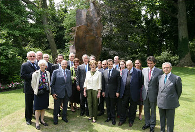 President George W. Bush, Laura Bush, and members of the U.S. delegation, join French President Nicolas Sarkozy and members of the French delegation, for a group photo following the unveiling of the Flamme de la Liberté sculpture Saturday, June 14, 2008, at the U.S. Ambassador's residence in Paris.
