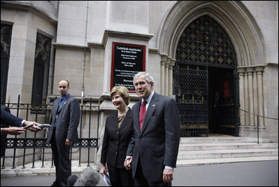 President George W. Bush and Laura Bush talk with reporters after attending Sunday morning church service at the American Cathedral of the Holy Trinity in Paris June 15, 2008.