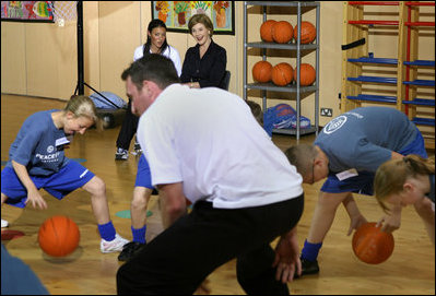 Mrs. Laura Bush watches a basketball demonstration at the Lough View Integrated Primary School's Gym in Belfast, Northern Ireland, June 16, 2008, during her visit to the school with President Bush. 