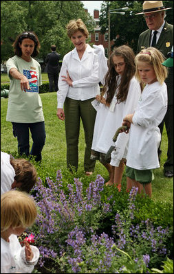 Mrs. Bush observes students of the Boys and Girls Club of Boston and Warren Prescott Elementary School who are planting gardens in the Charlestown Navy Yard Sunday, June 22, 2008 in Boston, MA, during a First Bloom event aimed at introducing children to plant species native to their area and educating kids about seed cultivation, garden design, and monitoring species.