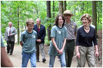 Mrs. Laura Bush walks on a trail in the Marsh-Billings-Rockefeller National Historical Park Monday, June 23, 2008, in Woodstock, Vt. With her are Rolf Diamant, park superintendent, and students of the Service-Learning program. President Bush has proclaimed 2008 as Great Outdoors Month to celebrate the grandeur of our open spaces, strengthen our commitment to preserving this heritage, and reaffirm our dedication to protecting our air, water, and lands.