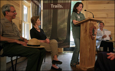 Mrs. Laura Bush listens to Rachel Allen, a student in the Service-Learning Program, as she delivers remarks during an Active Trails! event at Marsh-Billings-Rockefeller National Historical Park Monday, June 23, 2008, in Woodstock, Vt. Also shown are Rolf Diamant, Superintendent of Marsh-Billings-Rockefeller National Historical Park, and Vin Cipolla, President of the National Parks Foundation. Mr. Cipolla just announced a $50, 000 grant from the National Park Foundation to the Marsh-Billings-Rockefeller National Historical Park to connect the Forest Center to the Woodstock Trails Network.