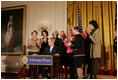 President George W. Bush is applauded by Mrs. Laura Bush, Cabinet members and members of Congress, at the proclamation signing for Women's History Month Monday, March 10, 2008 in the East Room of the White House in honor of Women's History Month and International Women's Day. From left are, U.S. Secretary of Labor Elaine Chao, U.S. Secretary of Transportation Mary Peters; New York Rep. Carolyn Mahoney, Rep. Marsha Blackburn of Tennessee, Rep. Judy Biggert of Illinois, Rep. Mary Fallin of Oklahoma, Rep. Shelley Moore Capito of West Virginia, Rep. Dianne Watson of California and Rep. Jean Schmidt of Ohio.