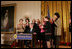 President George W. Bush is applauded by Mrs. Laura Bush, Cabinet members and members of Congress, at the proclamation signing for Women's History Month Monday, March 10, 2008 in the East Room of the White House in honor of Women's History Month and International Women's Day. From left are, U.S. Secretary of Labor Elaine Chao, U.S. Secretary of Transportation Mary Peters; New York Rep. Carolyn Mahoney, Rep. Marsha Blackburn of Tennessee, Rep. Judy Biggert of Illinois, Rep. Mary Fallin of Oklahoma, Rep. Shelley Moore Capito of West Virginia, Rep. Dianne Watson of California and Rep. Jean Schmidt of Ohio.