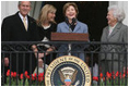 Mrs. Laura Bush, joined by President George W. Bush, daughter, Jena, and former first lady Barbara Bush, welcomes guests Monday, March 24, 2008 to the South Lawn of the White House, for the 2008 White House Easter Egg Roll.