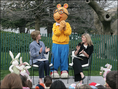 Mrs. Laura Bush, joined by her daughter, Jenna, applauds the PBS character "Arthur," following the reading of "Arthur Meets the President," Monday, March 24, 2008, during festivities at the 2008 White House Easter Egg Roll on the South Lawn of the White House.