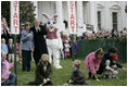 President George W. Bush, joined by Mrs. Laura Bush, blows a whistle Monday, March 24, 2008 on the South Lawn of the White House, to officially start the festivities for the 2008 White House Easter Egg Roll.