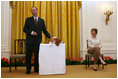 Mrs. Laura Bush looks on as the Westminster Kennel Club's 2008 Best in Show Winner, Uno, and his co-owner Eddie Dziuk address guests during their visit to the White House Monday, May 5, 2008, in the East Room of the White House.